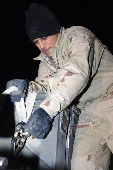 BAGRAM AIR FIELD, Afghanistan (AFPN) -- Staff Sgt. Bruno Carrasco secures MAU-169 computer control group fins to an ammunitions trailer here. The CCG detects laser energy reflected from a target, processes signals, and guides the GBU-12 munitions to the target. Since Sept. 15, the 455th munitions flight provided more than 23,000 rounds of 30mm ammunition, 15,000 countermeasures, 103 rockets, 14 500-pound air burst bombs and nine laser-guided bombs in support of the ongoing global war on terrorism. Sergeant Carrasco from El Paso, Texas, is deployed from Davis-Monthan Air Force Base, Ariz. (U.S. Air Force photo by Staff Sgt. Marcus McDonald)