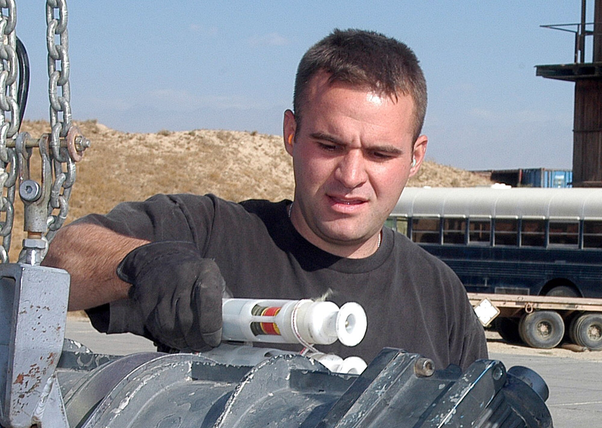 BAGRAM AIR FIELD, Afghanistan (AFPN) -- Staff Sgt. Nicholas O'Reilly processes 30mm high-explosive cannon ammunition here using a GFU-7. The machine, sometimes referred to as the "Dragon," separates the brass from the ammunition downloaded from A-10 Thunderbolts and returns the good rounds to another can, making it reusable for reloading onto the combat aircraft. Since Sept. 15, the 455th munitions flight provided more than 23,000 rounds of 30mm ammunition, 15,000 countermeasures, 103 rockets, 14 500-pound air burst bombs and nine laser-guided bombs in support of the ongoing global war on terrorism. Sergeant O'Reilly from Chicago, Ill., is deployed from Davis-Monthan Air Force Base, Ariz. (U.S. Air Force photo by Staff Sgt. Marcus McDonald) 