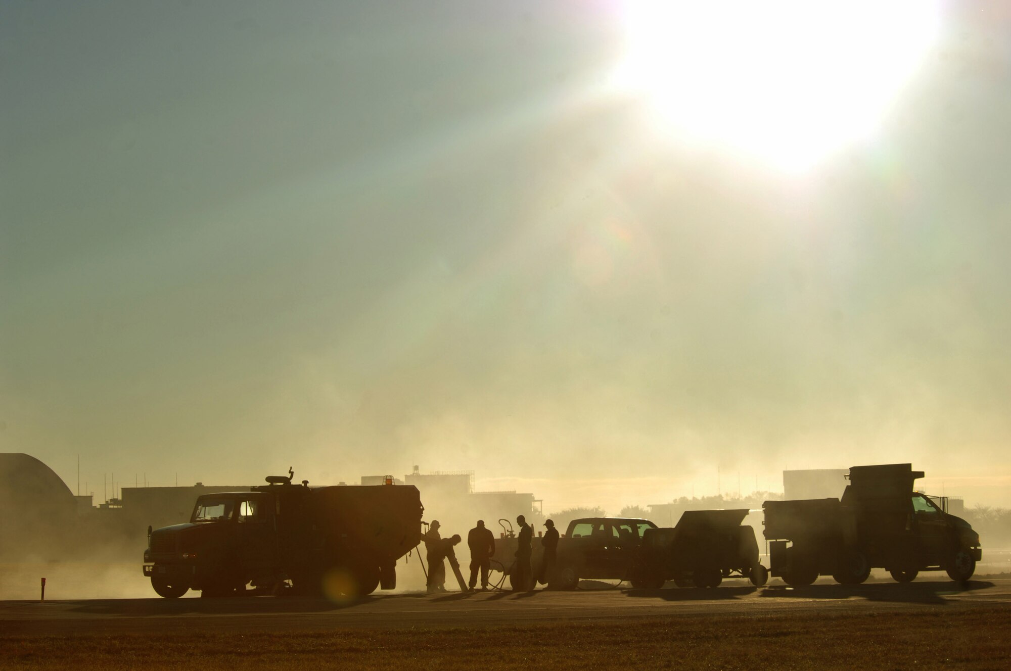 YOKOTA AIR BASE, Japan (AFPN) -- Airmen conduct an early-morning inspection on the flightline.  They are trained to deploy into bare-base locations, assess airfield capabilities, prepare aircraft landing areas, clear obstacles, install emergency airfield lighting systems and repair airfield damage. The Airmen are members of the 374th Civil Engineer Squadron. (U.S. Air Force photo by Master Sgt. Val Gempis)