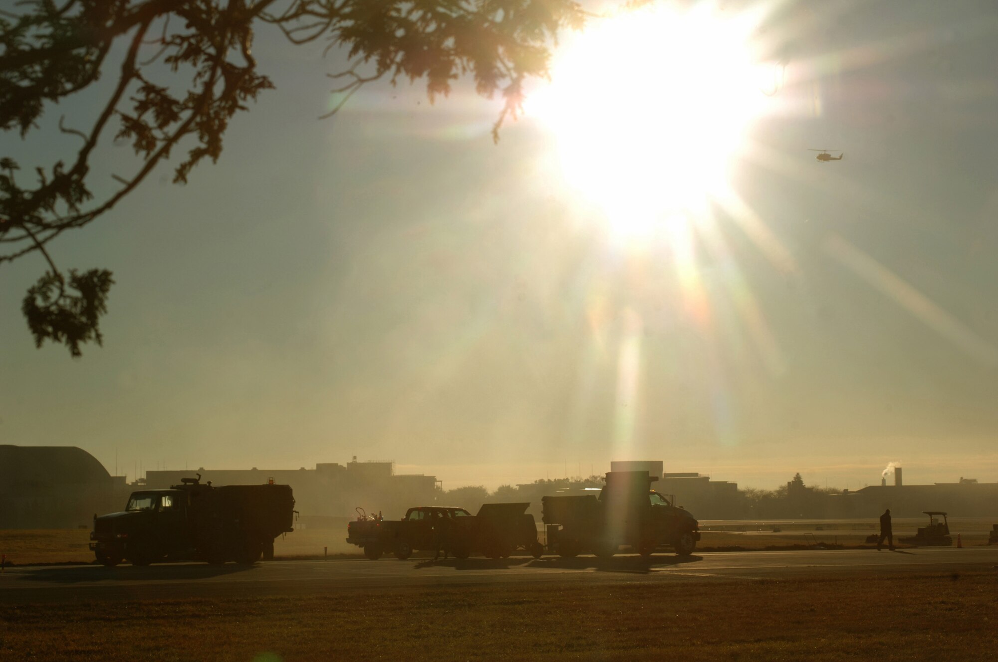 YOKOTA AIR BASE, Japan (AFPN) -- Airmen conduct an early-morning inspection on the flightline. They are trained to deploy into bare-base locations, assess airfield capabilities, prepare aircraft landing areas, clear obstacles, install emergency airfield lighting systems and repair airfield damage. The Airmen are members of the 374th Civil Engineer Squadron.  (U.S. Air Force photo by Master Sgt. Val Gempis)
