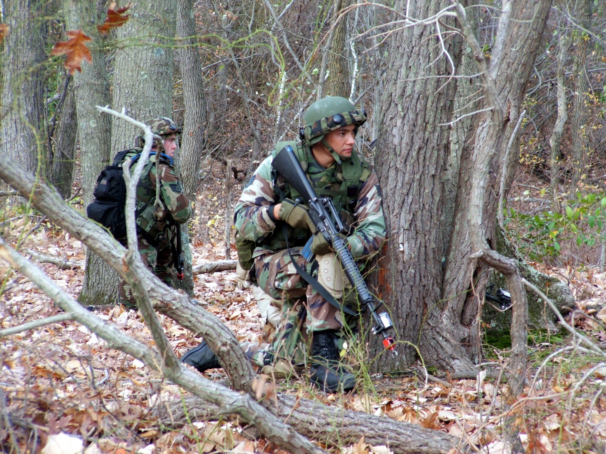 FORT DIX, N.J. (AFPN) -- Airmen take cover as part of combat patrol and tactics training for the Combat Interrogator Course.  The course teaches Airmen various contingency skills for their deployments.  The Air Mobility Warfare Center's 421st Combat Training Squadron teaches the course.  (U.S. Air Force photo by Tech. Sgt. Scott T. Sturkol)