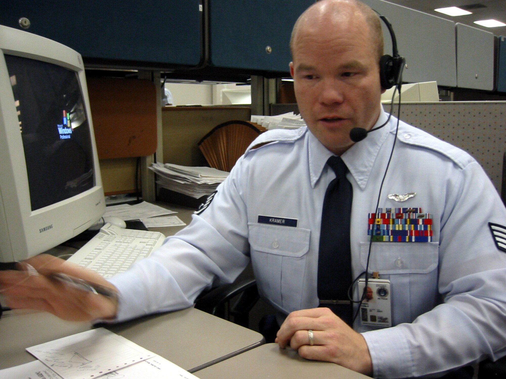 Staff Sgt. Craig Kramer answers a call during business hours.  Sergeant Kramer and others respond to better than 14,000 inqueries per month. (Photo by Tech. Sgt. Jason Tudor)
