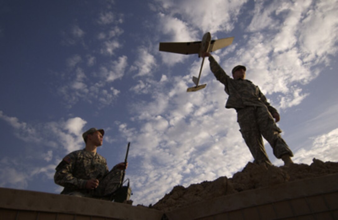 Army Spc. Ted Trenary (left) and Pfc. Kevin Tirserio (right) prepare to launch a Raven unmanned aerial vehicle from Forward Operations Base McHenry, Iraq, on Nov. 30, 2005. The soldiers will fly the Raven over Route Trans-Am to scan for improvised explosive devices. Trenary and Tirserio are attached to the 101st Airborne Division deployed from Fort Campbell, Ky. 