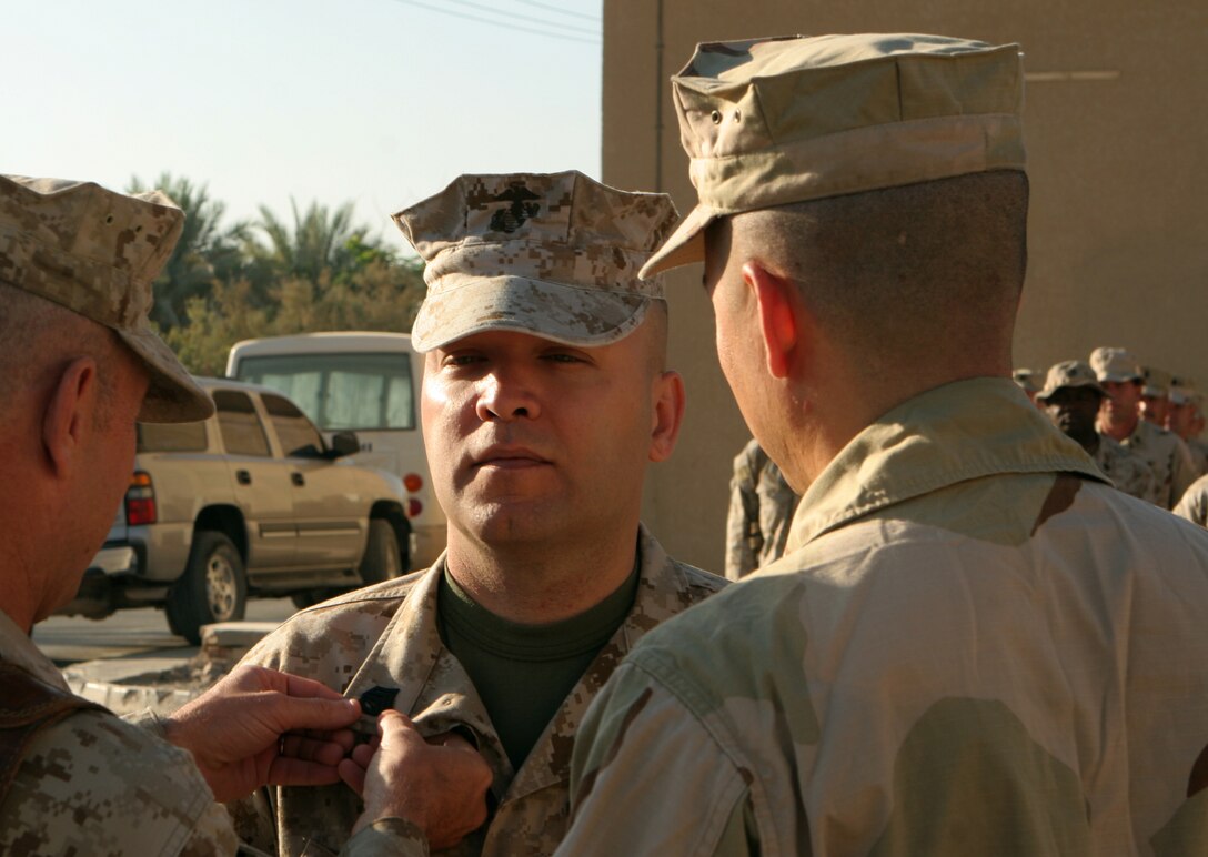 Lance Cpl. Carlos Johnson, a 1/3 motor transportation operator from Atlanta, flashes a smile after adjusting the mirror on his 7-ton truck at the Camp Wilson motor pool at the Marine Corps Air Ground Combat Center in Twentynine Palms, Calif.  Jonson is now the senior lance corporal with 1/3's Motor T division, a far cry from when he found himself as a boot private first class transporting Marines and supplies while under fire during the battle in Fallujah barely a month after graduating from MOS school and reporting to Marine Corps Base Hawaii, Kaneohe Bay.