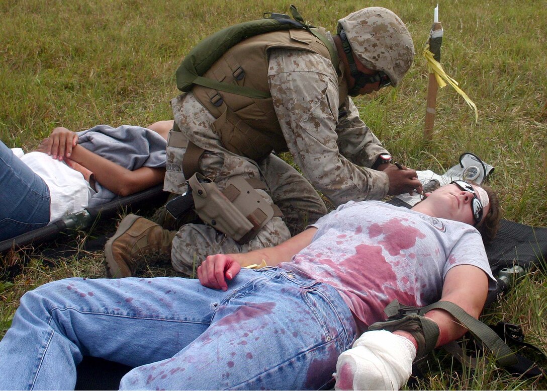 A Navy Corpsman assigned to MEU Service Support Group 22 evaluates a "casualty" in the triage phase of a mass casualty exercise during the 22nd Marine Expeditionary Unit's Certification Exercise (CERTEX), Oct. 1, 2005.  CERTEX is the MEU's final exercise predeployment exercise before deploying later this year.