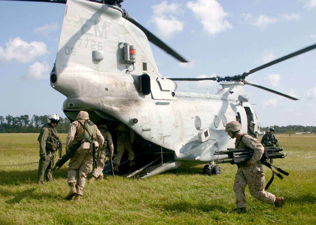 Marines from MEU Service Support Group 22 sprint onto a CH-46E Sea Knight helicopter during the final stages of a mass casualty exercise during a recent Certification Exercise (CERTEX), Oct. 1, 2005.  MSSG-22 is the combat service support element of the 22nd Marine Expeditionary Unit (MEU).