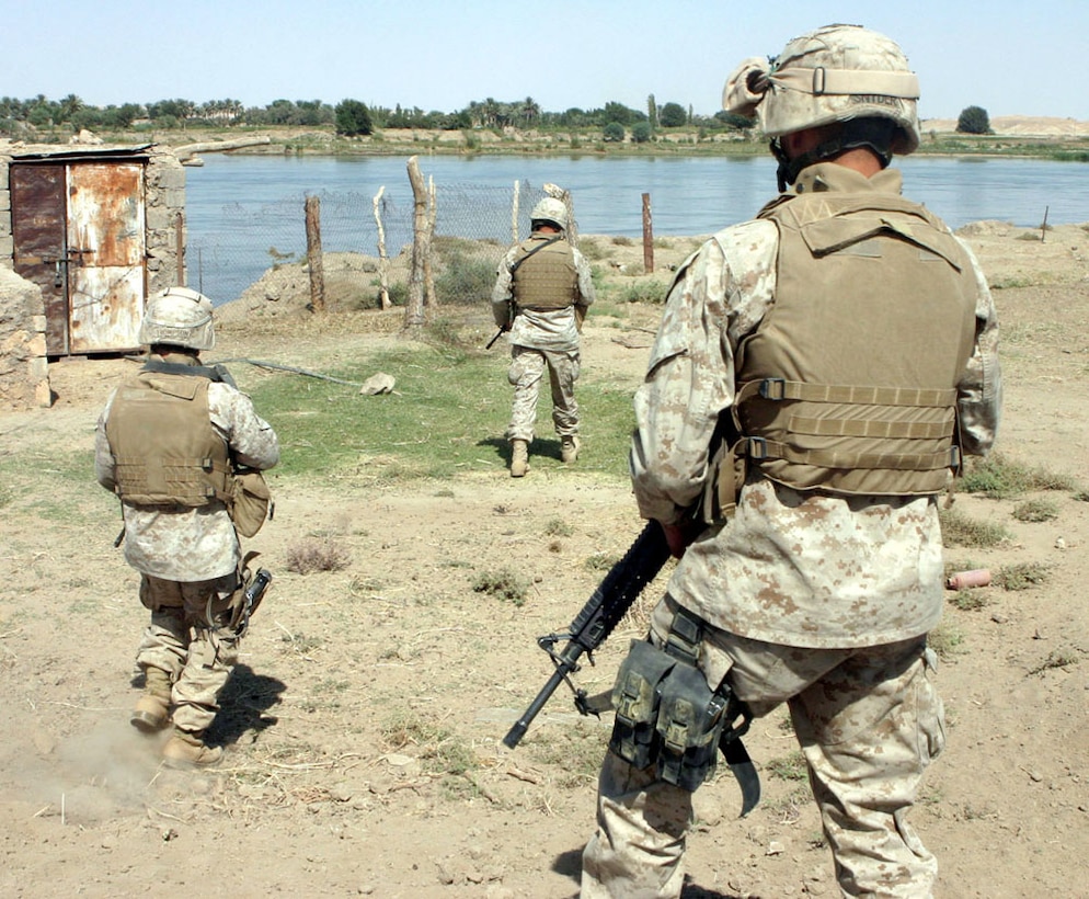 Three Marines from Weapons Company, 3rd Battalion, 6th Marine Regiment, patrol along the Euphrates River Oct. 3, 2005, during Operation Iron Fist, a counterinsurgency operation the Marines conducted last year in the western Al Anbar province towns of Sa'dah and Eastern Karabilah.  After spending seven months of routing out insurgents and stabilizing the Al Qa?im region, located along the Euphrates River in northwestern Al Anbar Province near the Syrian border, the Camp Lejeune, N.C.-based Marines say they?re leaving the region in better shape then when they arrived last year. During the past seven months, the Marines have brought stability back to the people of western Iraq by training Iraqi Army soldiers and ridding the region of anti-Iraqi forces, thanks to an aggressive counterinsurgency campaign, which included Operation Steel Curtain last November - a major offensive to disrupt insurgent activity along the Syrian border which saw hundreds of insurgents killed or captured. ?We're able to progress now with getting consistent (electrical) power, free and clean running water for all the villages up there, as well as starting to rebuild the hospitals and the schoolhouses that have suffered over the last three years,? said Col. Stephen W. Davis, who commanded all Marine forces in western Al Anbar Province for the past year, during a Pentagon press briefing last month. The battalion?s redeployment to the U.S. is part of a regularly scheduled rotation of forces in Al Anbar. More than 25,000 Marine and sailors of Camp Pendleton, Calif.-based I Marine Expeditionary Force are replacing the Camp Lejeune, N.C.-based II MEF. (Official U.S. Marine Corps photo by Sgt. Jerad W. Alexander)