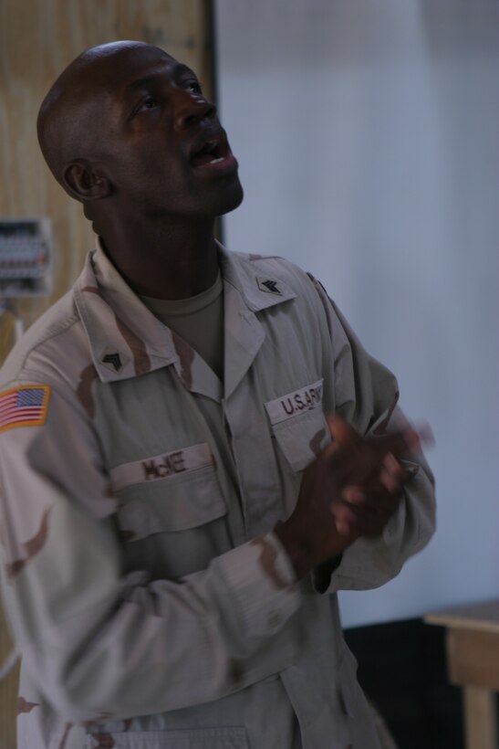 CAMP TAQADDUM, Iraq (Oct. 3, 2005) ? Army Sgt. Alphadel McKee, a member of the Camp Taqaddum gospel band sings here Oct. 2. The band, made up of 15 service members from the Marine Corps, Army, and Navy, performs in front of a respectively large crowd of worshippers at the Taqaddum chapel every week. McKee is an infantryman with 112th Infantry Division.