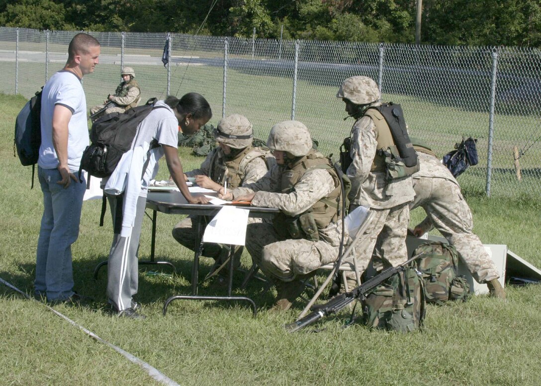Marines from MEU Service Support Group 22 process evacuess during a non-combatant evacuation operation (NEO) training exercise during the 22nd Marine Expeditionary Unit's Certification Exercise (CERTEX), Oct. 2, 2005.  CERTEX was the final predeployment exercise undertaken by the MEU before it deploys later this year.