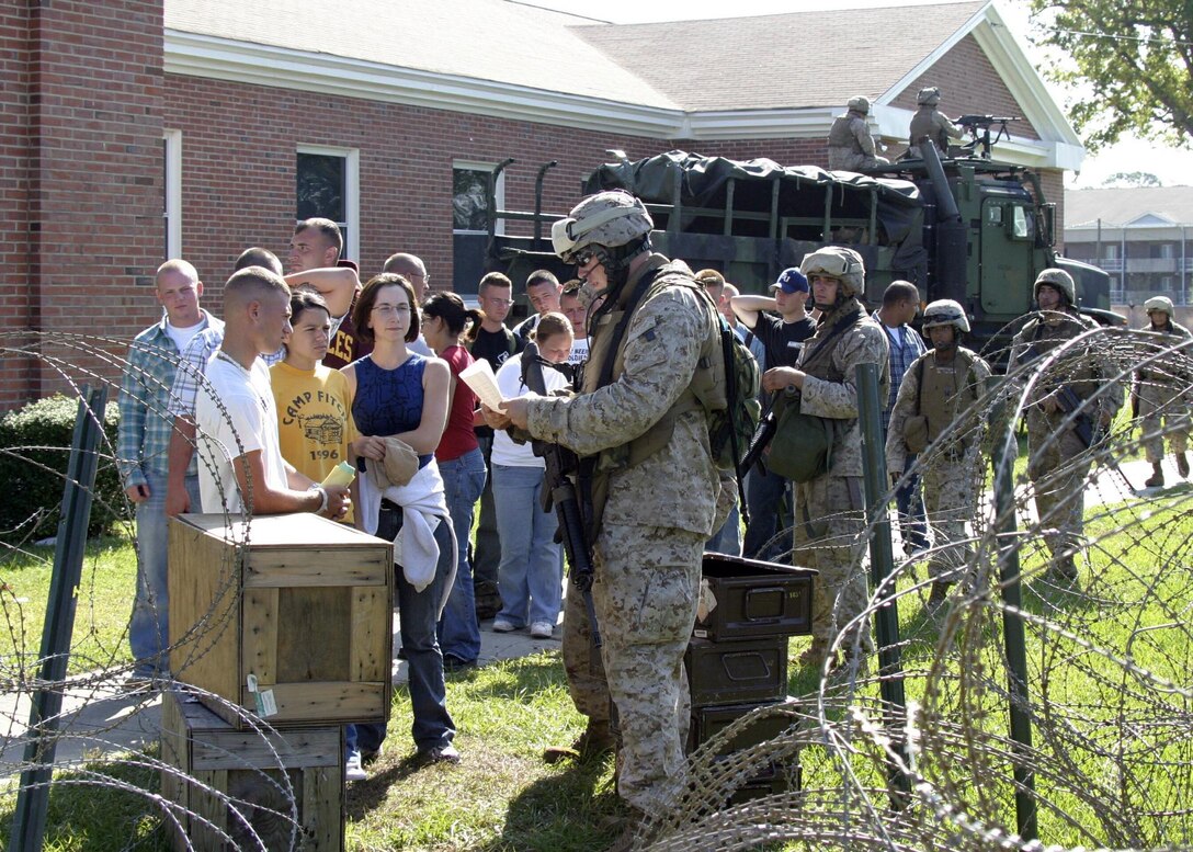 Marines from Golf Battery, Battalion Landing Team 1st Bn., 2nd Marines and MEU Service Support Group 22 process evacuees during a noncombatant evacuation operation (NEO) exercise aboard Camp Lejeune during the 22nd Marine Expeditionary Unit's recent Certification Exercise (CERTEX), Oct. 2, 2005.  CERTEX was the final predeployment exercise undertaken by the MEU before it deploys later this year.