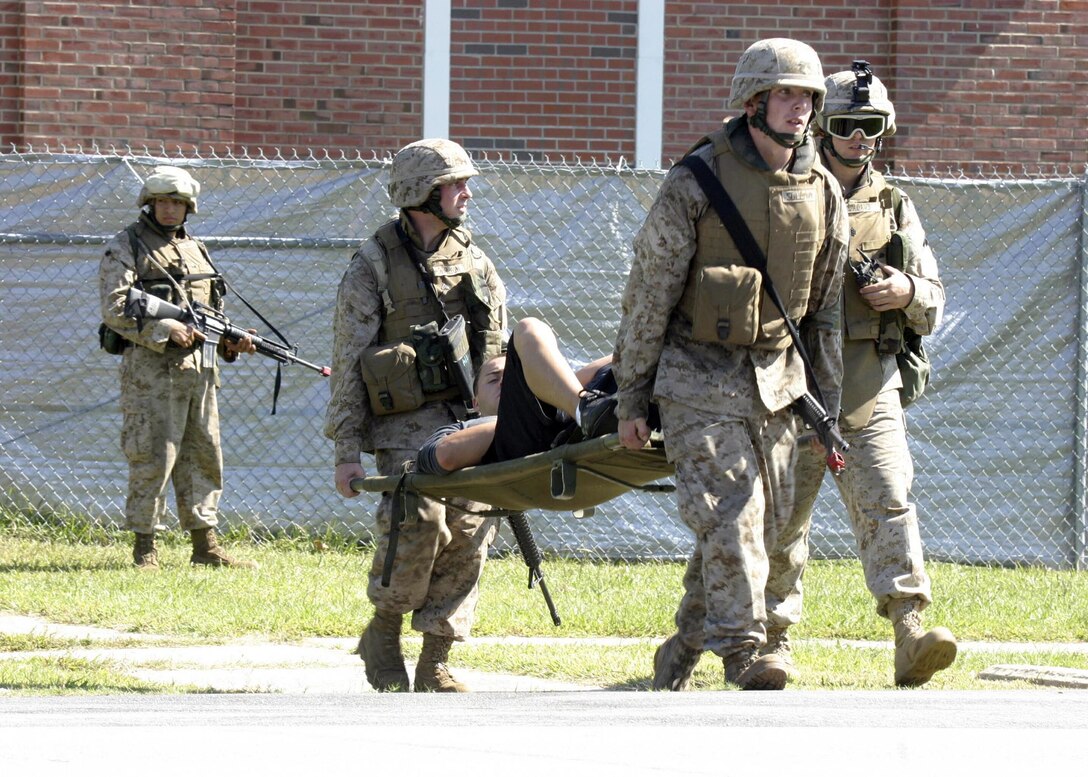 Marines from Golf Battery, Battalion Landing Team 1st Bn., 2nd Marines carry an 'injured' civilian to be evacuated during a noncombatant evacuation operation (NEO) exercise during the 22nd Marine Expeditionary Unit's recent Certification Exercise (CERTEX), Oct. 2, 2005.  CERTEX was the final predeployment exercise undertaken by the MEU before it deploys later this year.