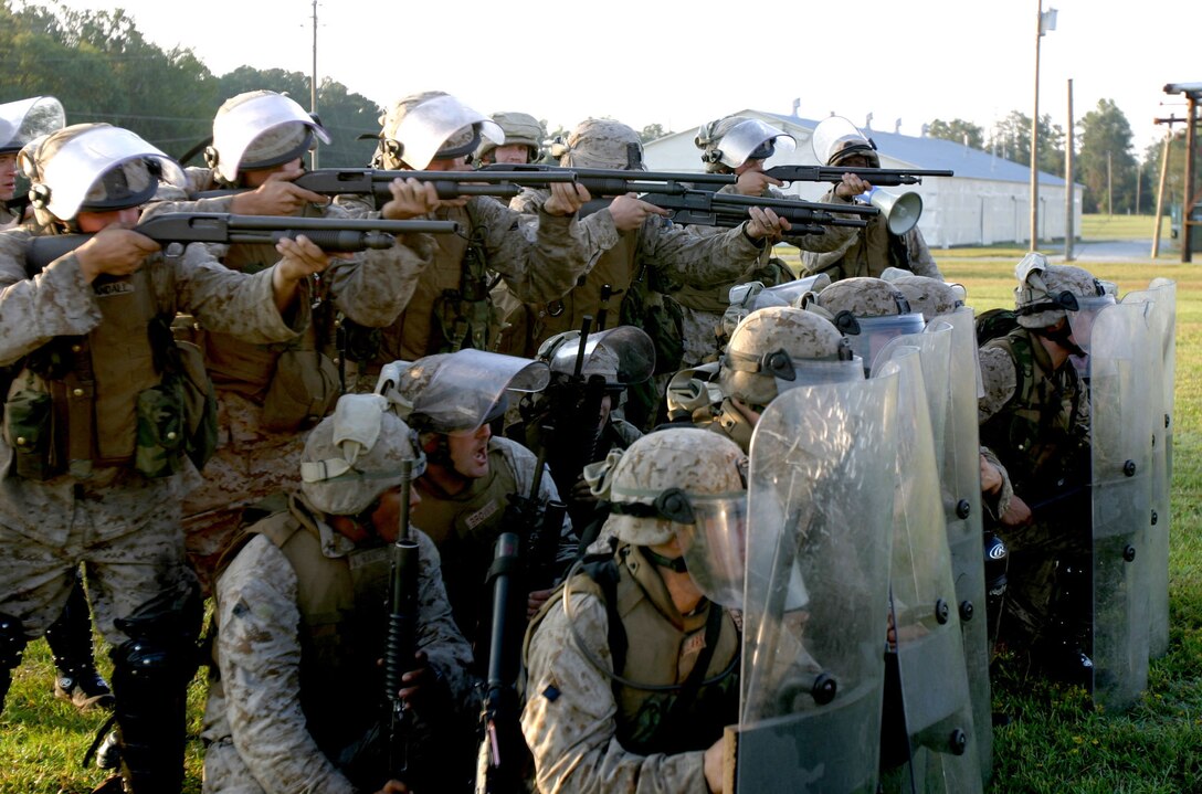 Infantrymen from Bravo Co., Battalion Landing Team 1st Bn., 2nd Marines practice riot control tactics in preparation for a noncombatant evacuation operation (NEO) exercise aboard Camp Lejeune during the 22nd Marine Expeditionary Unit's recent Certification Exercise (CERTEX), Oct. 2, 2005.  BLT 1/2 is the MEU's ground combat element, and is scheduled to deploy later this year.