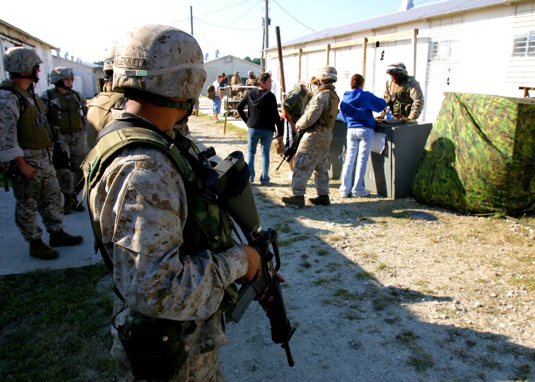 Marines from Bravo Co., Battalion Landing Team 1st Bn., 2nd Marines provide security inside an evacuation control center (ECC) during a noncombatant evacuation operation (NEO) exercise aboard Camp Lejeune during the 22nd Marine Expeditionary Unit's recent Certification Exercise (CERTEX), Oct. 2, 2005.  BLT 1/2 is the MEU's ground combat element, and is scheduled to deploy later this year.