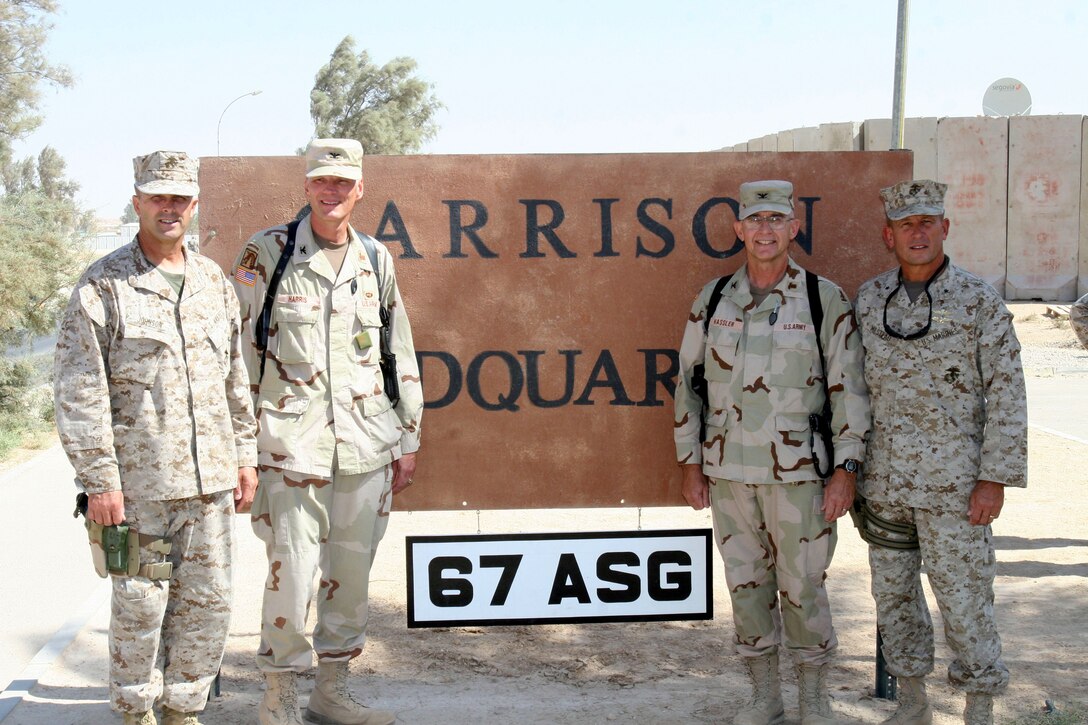 Major Gen. Stephen T. Johnson, the commanding general of II Marine Expeditionary Force (Forward), and Brig. Gen. Robert E. Milstead, the commanding general of 2nd Marine Aircraft Wing (Fwd.), stand with Col. George R. Harris, garrison commander of the 326th Area Support Group, and Col. Kenneth E. Hassler, commanding officer of the 67th ASG, after a transfer of authority ceremony, Oct. 4, at Al Asad, Iraq. During the ceremony, the 67th ASG, a Lincoln, Neb. Army National Guard unit, relieved the 326th ASG.