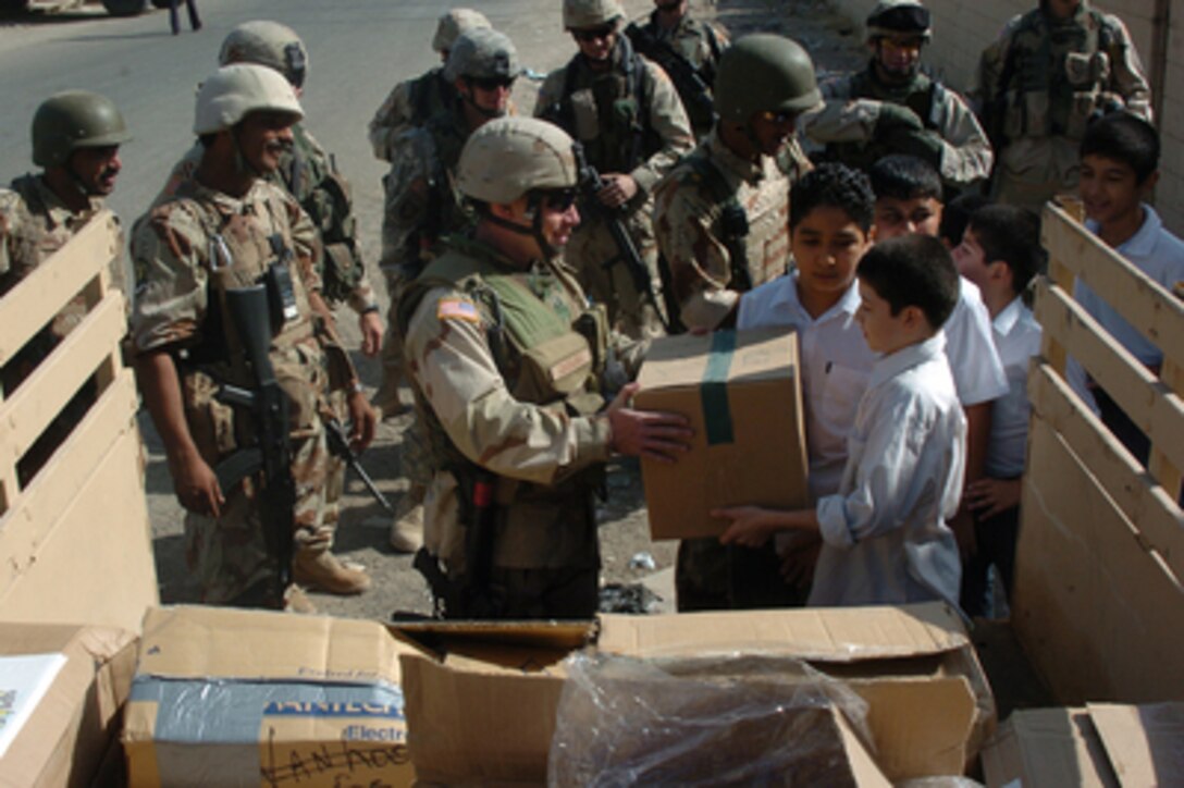 U.S. Army soldiers attached to 4th Brigade, 3rd Infantry Division and Iraq Army soldiers drop off school supplies at a children's elementary school in Baghdad, Iraq, on Sept 25, 2005. 