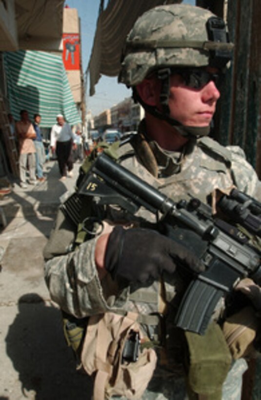 A U.S. Army soldier from the 1st Battalion, 17th Infantry Regiment, 172nd Stryker Brigade Combat Team keeps a sharp watch down a road during a patrol in Mosul, Iraq, on Sept. 29, 2005. 