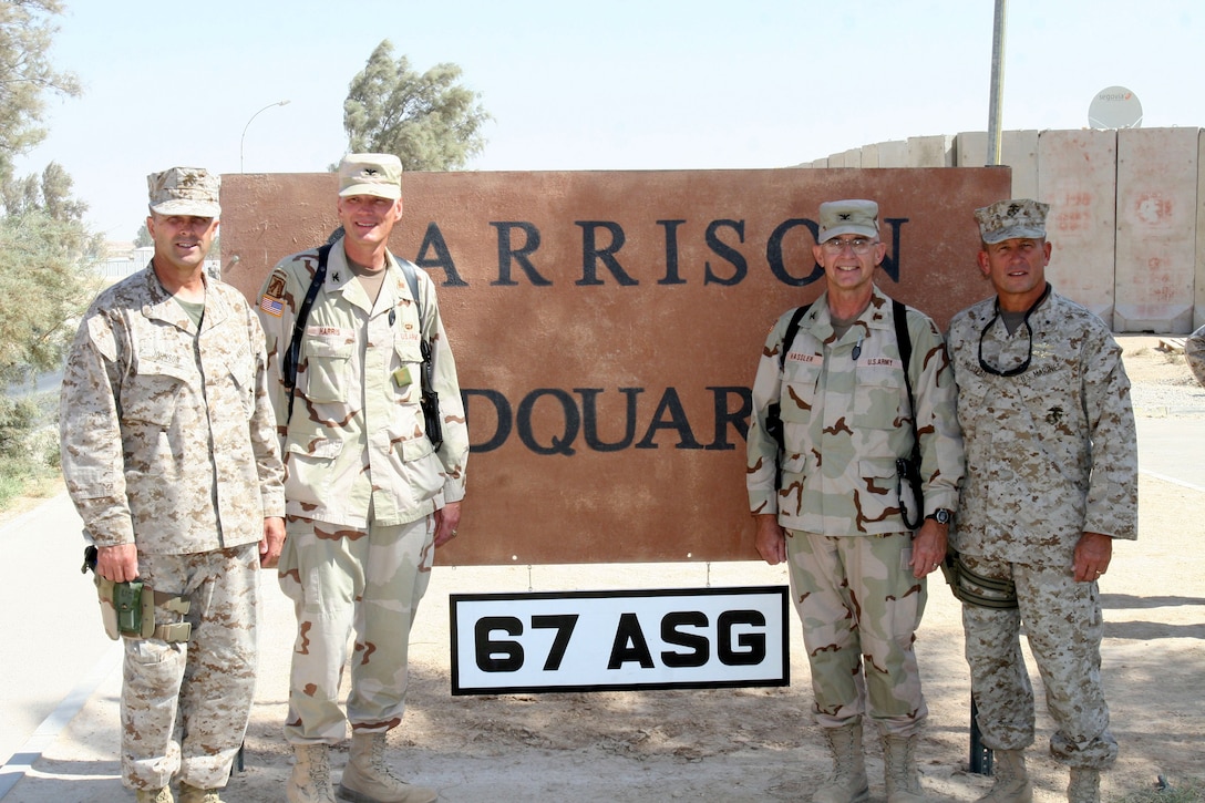 Major Gen. Stephen T. Johnson, the commanding general of II Marine Expeditionary Force (Forward), and Brig. Gen. Robert E. Milstead, the commanding general of 2nd Marine Aircraft Wing (Fwd.), stand with Col. George R. Harris, garrison commander of the 326th Area Support Group, and Col. Kenneth E. Hassler, commanding officer of the 67th ASG, after a transfer of authority ceremony, Oct. 4, at Al Asad, Iraq. During the ceremony, the 67th ASG, a Lincoln, Neb. Army National Guard unit, relieved the 326th ASG.