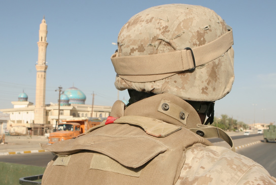 Lance Cpl. Joe M. Kauffman, a gunner who provides security for Team 3 during routine operations, provides security for a CAG convoy in Fallujah Oct. 4. Kauffman, a reserve Marine from Philadelphia, said he wants to help make life better for the Iraqi people.