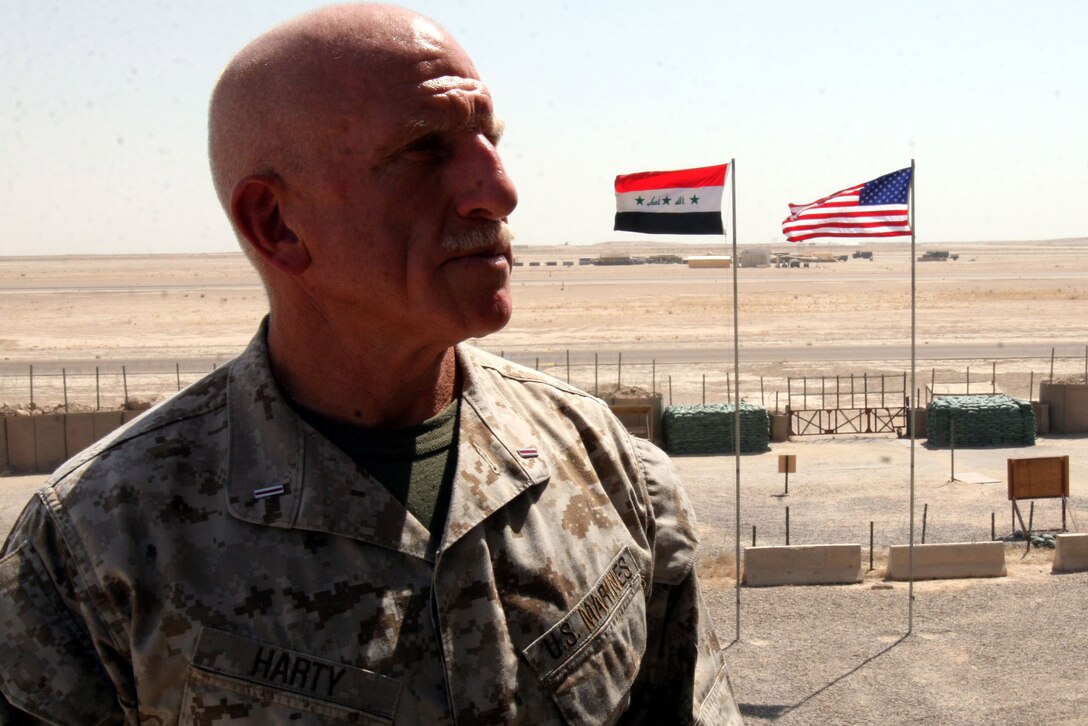 AL TAQADDUM, Iraq (Aug. 15, 2007) ? CWO 5 Christopher Harty stands atop his workspace in Iraq overlooking the American and Iraqi flags. The 56-year-old was recalled from retirement for the second time to serve a deployment here as a liaison officer. Even though the Medford Lakes, N.J., native retired from the Marine Corps and police force in 2000, he continued to work as a college professor and for the state before again volunteering his services to the Corps.