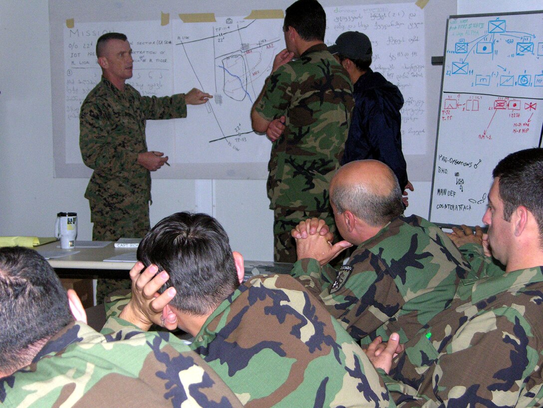 Capt. Jason P. Richter, 37, the Georgia Sustainment and Stability Operations Program operations officer and native of Rochester, Mich., teaches the Republic of Georgia 22nd Light Infantry Battalion staff at Krtsanisi, Georgia. As partners in the Global War on Terror, Marines of the Georgia Sustainment and Stability Operations Program U.S. Task Force finished training the former-Soviet Republic of Georgia 22nd Light Infantry Battalion staff at Krtsanisi, Georgia, Dec. 16. The GSSOP-trained 22nd Light Infantry Battalion troops will form part of the dedicated force called for in UN Security Council Resolution 1546 to protect UN forces in Iraq.