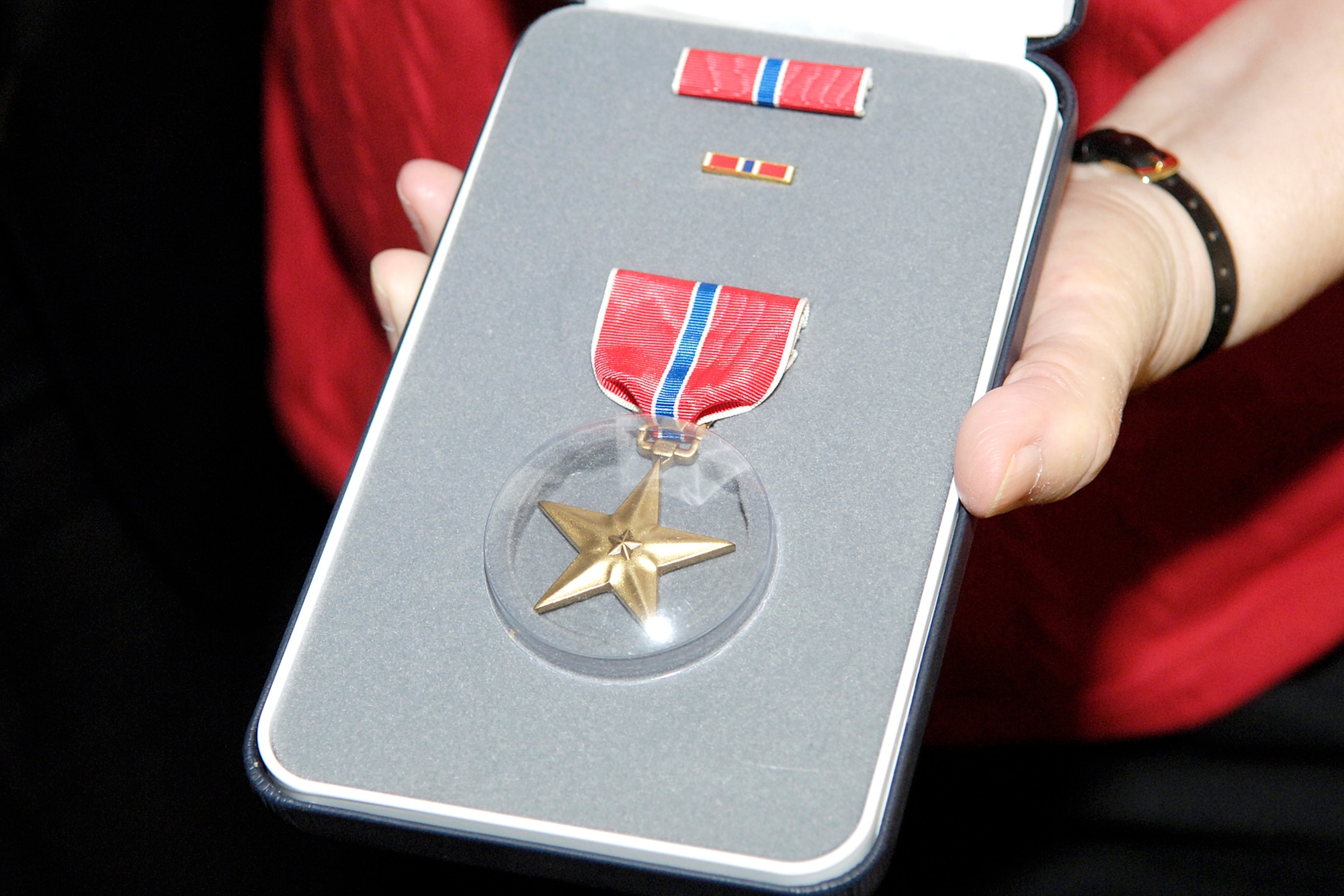 BREWER, Maine -- The Bronze Star was posthumously presented to Staff Sgt. Merle Y. Strang on Sept. 27.  Accepting the medal on his brother's behalf was the Rev. Homer Strang.  Sergeant Strang was awarded the Bronze Star for his participation in the Korean War's Kiddie Car Airlift, where he was credited for saving the lives of 950 orphans and 100 orphanage staff members.  (U.S. Air Force photo by Tech. Sgt. Michael Brogan)