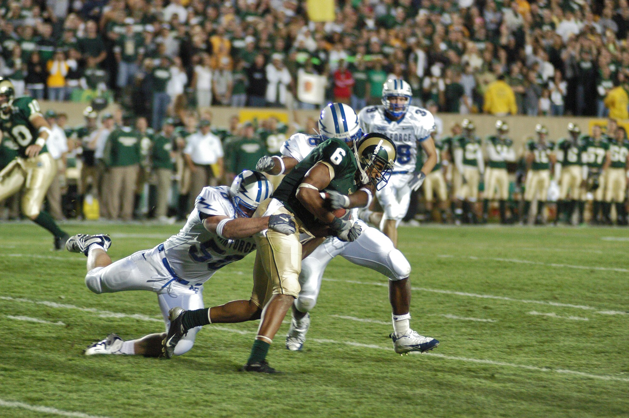 FORT COLLINS, Colo. -- Air Force special teamers Aaron Shanor, 50, and Jared Baxley, 26, wrap up Colorado State University kick returner Robert Herbert Sept. 29 in Fort Collins. (U.S. Air Force photo by John Van Winkle)
