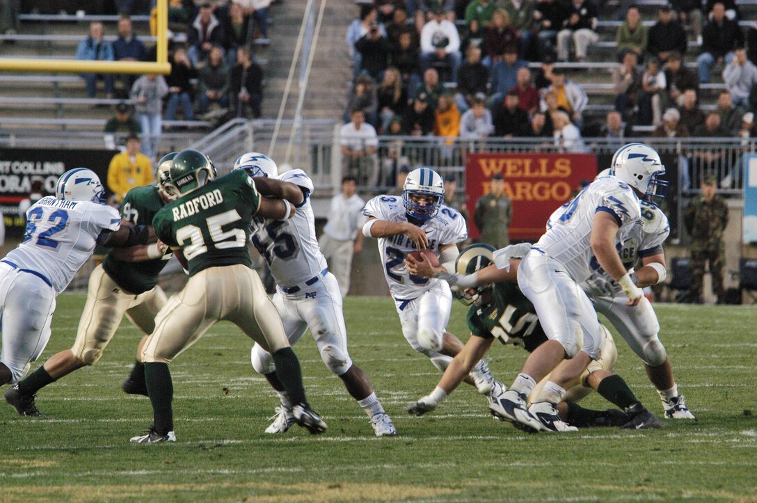 FORT COLLINS, Colo. -- Air Force halfback Chad Hall, 23, looks for running room as fullback Ryan Williams, 45, and company clear the way through the Colorado State University defense. (U.S. Air Force photo by John Van Winkle)