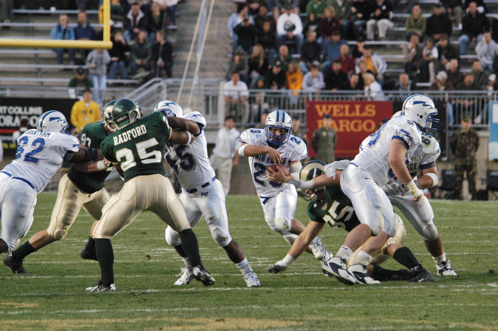 FORT COLLINS, Colo. -- Air Force halfback Chad Hall, 23, looks for running room as fullback Ryan Williams, 45, and company clear the way through the Colorado State University defense. (U.S. Air Force photo by John Van Winkle)