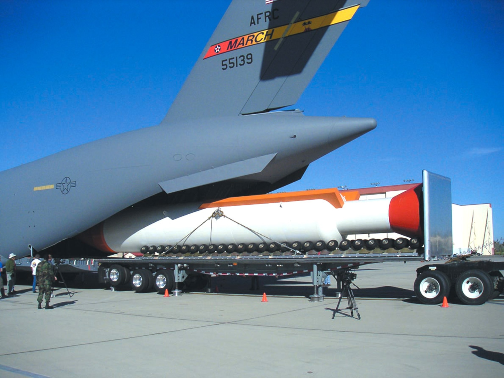 EDWARDS AIR FORCE BASE, Calif. -- Test crews load, a 65-foot mock-up booster rocket onto a C-17 Globemaster III. The rocket will be used to test aerial launch capabilities for rockets. (U.S. Air Force photo by Brad White)