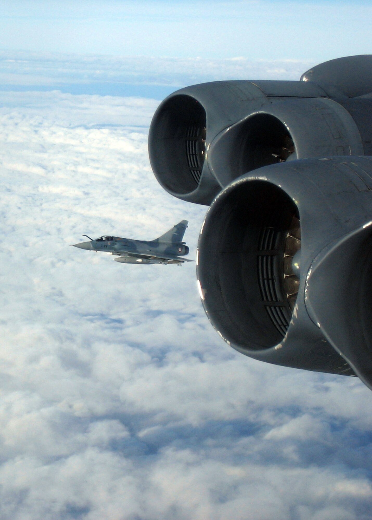 OVER FRANCE -- A French air force Mirage 2000 fighter escorts a B-52 Stratofortress. The bomber from Barksdale Air Force Base, La., was en route to Egypt to participate in exercise Bright Star 2005. The exercise began Sept. 10 and ended Oct. 3. It included forces from the United States, Egypt, France and 11 other countries. (U.S. Air Force photo by 1st Lt. Daniel Decker) 
