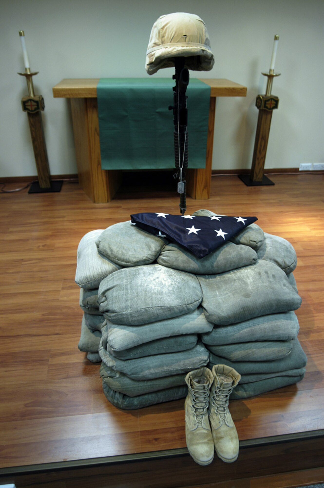 SOUTHWEST ASIA -- A final memorial tribute to Airman 1st Class Elizabeth Jacobson sits at the base chapel Oct 6. The helmet and identification tags represent the fallen servicemember, the combat boots signify the final march of the last battle and the inverted rifle with a bayonet symbolize a time for prayer and a break in the action to pay tribute to a fallen comrade. Airman Jacobson was deployed to a forward-deployed location supporting Operation Iraqi Freedom and was killed in the line of duty Sept. 28. (U.S. Air Force photo by Staff Sgt. Scott Campbell)