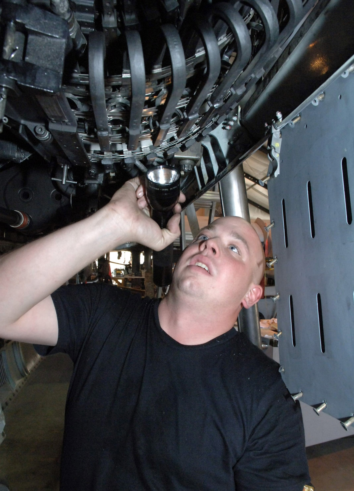 BAGRAM AIR BASE, Afghanistan -- Senior Airman James Maskal, inspects the feed shoot on an A-10 Thunderbolt II gatling gun during a recent phase inspection here. A-10s are inspected every 400 flying hours. In September, A-10s here flew 380 direct close-air support sorties supporting Operation Enduring Freedom. Airman Maskal is an armament specialist with the 455th Expeditionary Aircraft Maintenance Squadron and is deployed from Davis-Monthan Air Force Base, Ariz. (U.S. Air Force photo by Capt. James H. Cunningham)