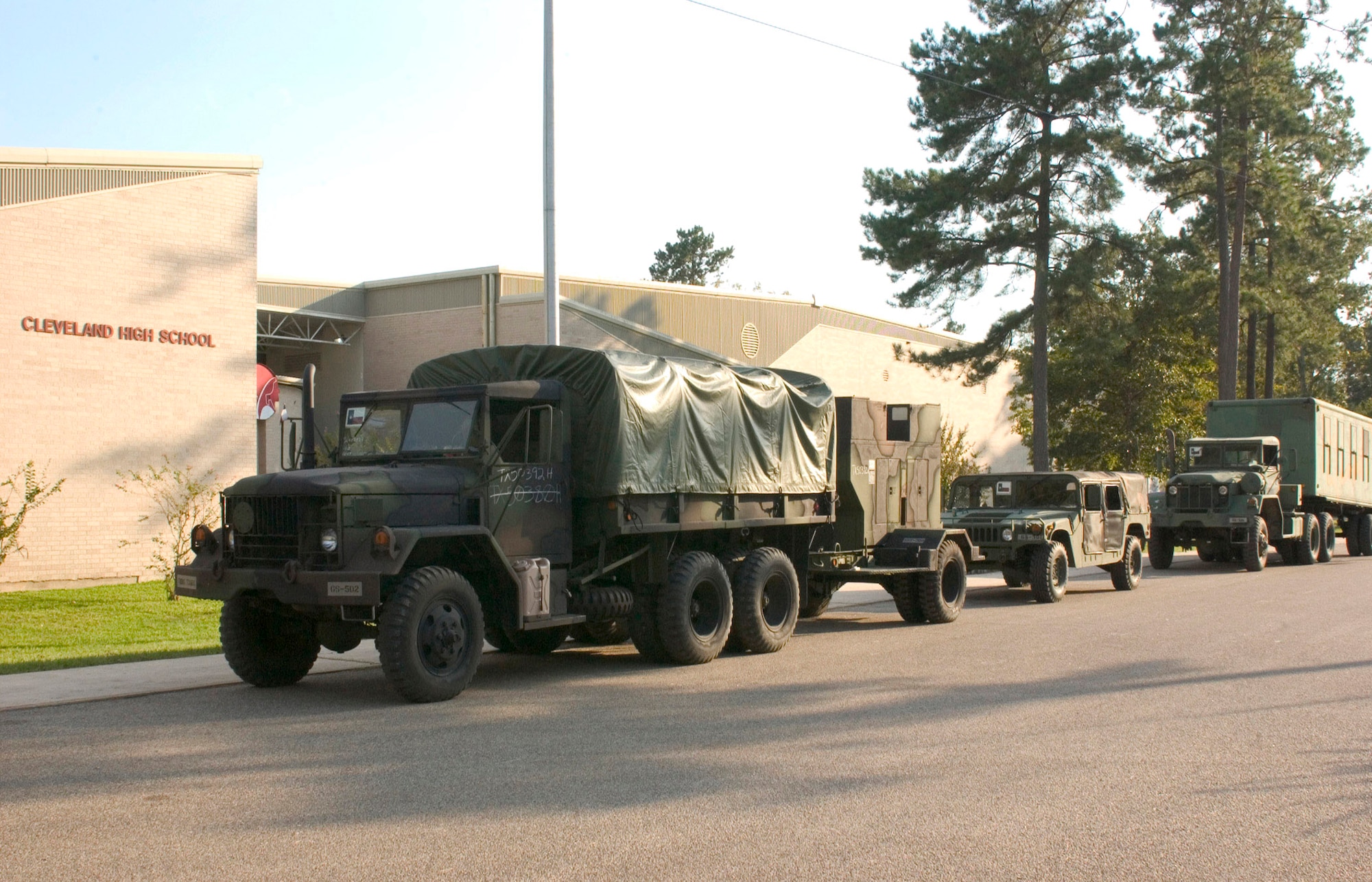 CLEVELAND, Texas -- Texas National Guard vehicles line up in front of a local high school in preparation for departure Oct. 5.  Three hundred guardsmen with Task Force-Seguin staged out of the school to assist with food and water distribution in surrounding counties after Hurricane Rita.  (U.S. Air Force photo by Senior Master Sgt. Mike Arellano)