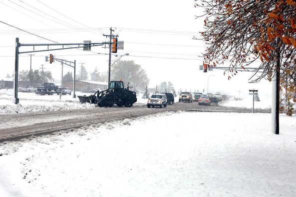 MINOT AIR FORCE BASE, N.D. -- A 5th Civil Engineer Squadron snowplow clears an intersection here after the first snowfall of the year.  Only mission-essential Airmen reported to duty because of the storm.  As of 11 a.m. on Oct. 5, the base had received 5 inches of snow, winds averaging 45 mph and a temperature of 32 degrees.  (U.S. Air Force photo by Staff Sgt. Joe Laws)