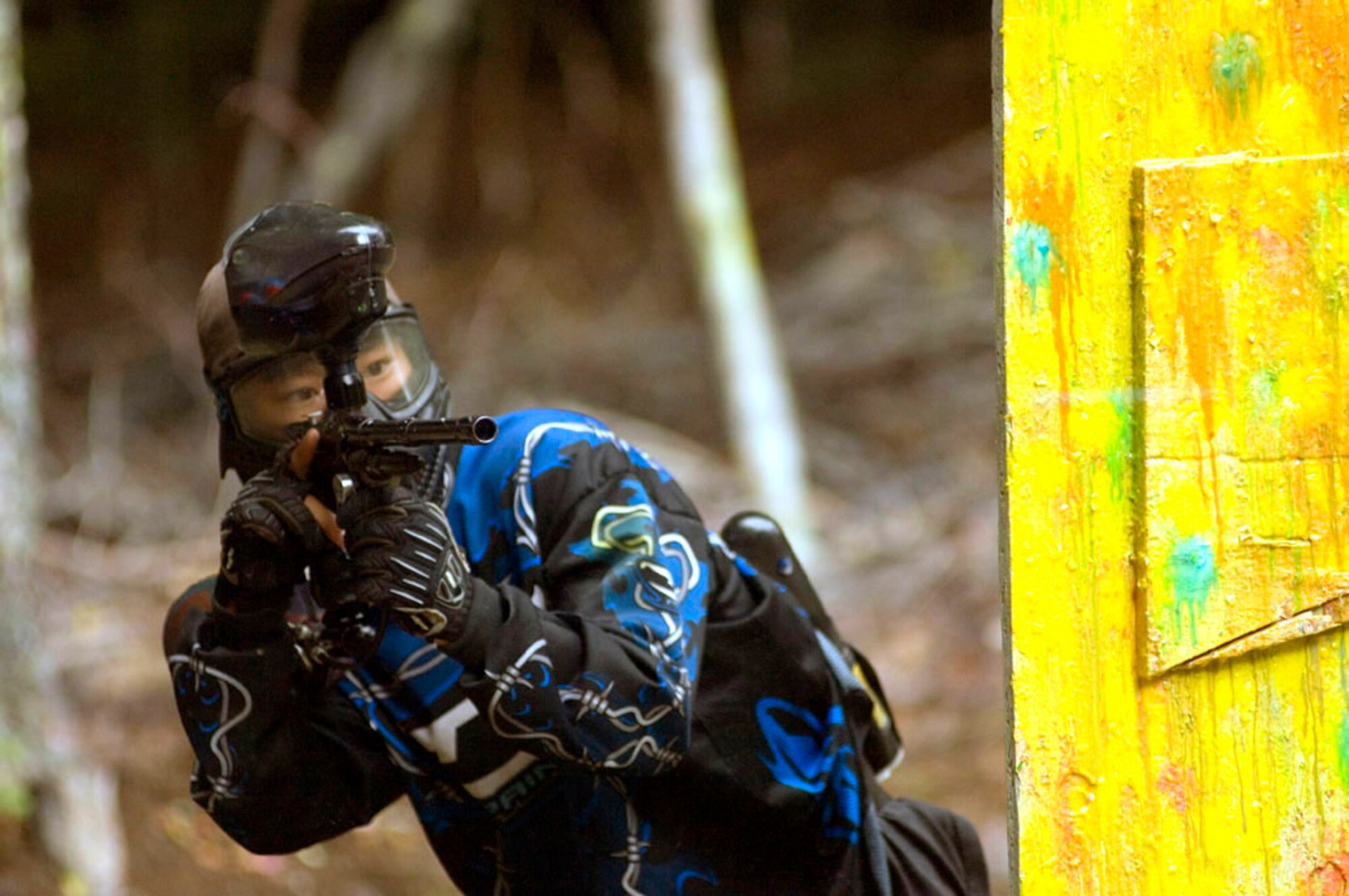 PULASKI BARRACKS, Germany -- A paintballer leans out from behind an obstacle and takes aim during the first speedball tournament here. Two three-person teams competed against each other from opposite ends of an enclosed area during a three-minute contest.  Fifteen American and German teams participated in the competition.  (U.S. Air Force photo by Master Sgt. John E. Lasky)