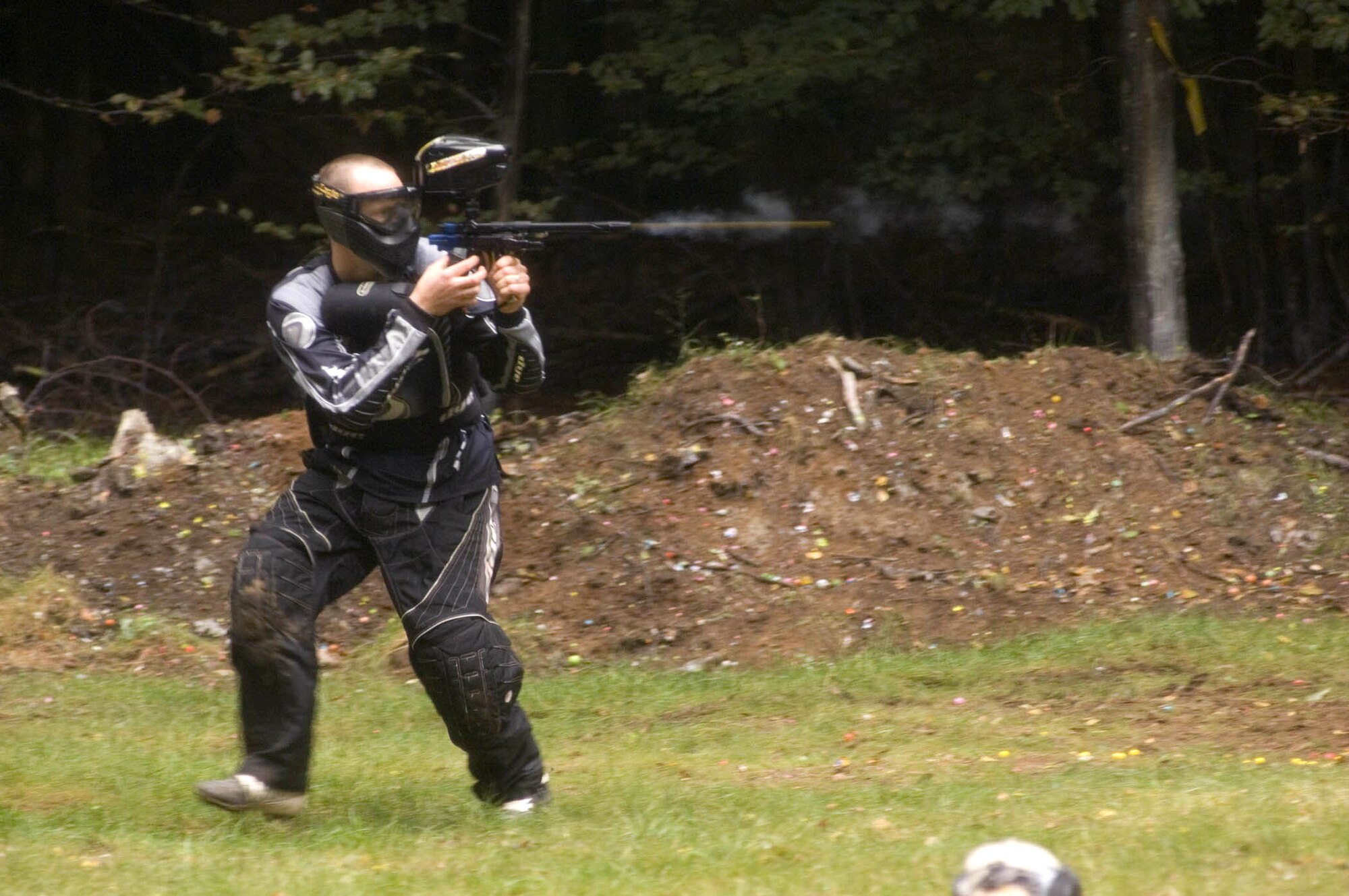 PULASKI BARRACKS, Germany -- A paintballer shoots and moves during the first speedball tournament here. Two three-person teams try to mark the other team from opposite ends of an enclosed area competed against each other from opposite ends of an enclosed area during a three-minute contest.  Fifteen American and German teams participated in the competition.  (U.S. Air Force photo by Master Sgt. John E. Lasky)