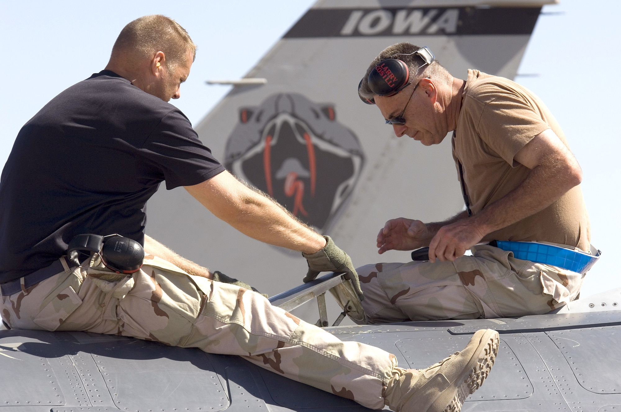 MORON AIR BASE, Spain -- Tech. Sgt. Stephen Jennings (left) and Master Sgt. Larry Lostell check an F-16 Fighting Falcon's inflight refueling door after landing here with "Coronet East."  The fuel systems technicians from the 180th Fighter Wing at Toledo, Ohio, are on their way home after supporting Operation Iraqi Freedom.  Coronet East is a title given to a group of jet fighters flying with necessary tankers for air refueling and an air transport with necessary maintenance support in tow.  (U.S. Air Force photo by Master Sgt. John E. Lasky) 