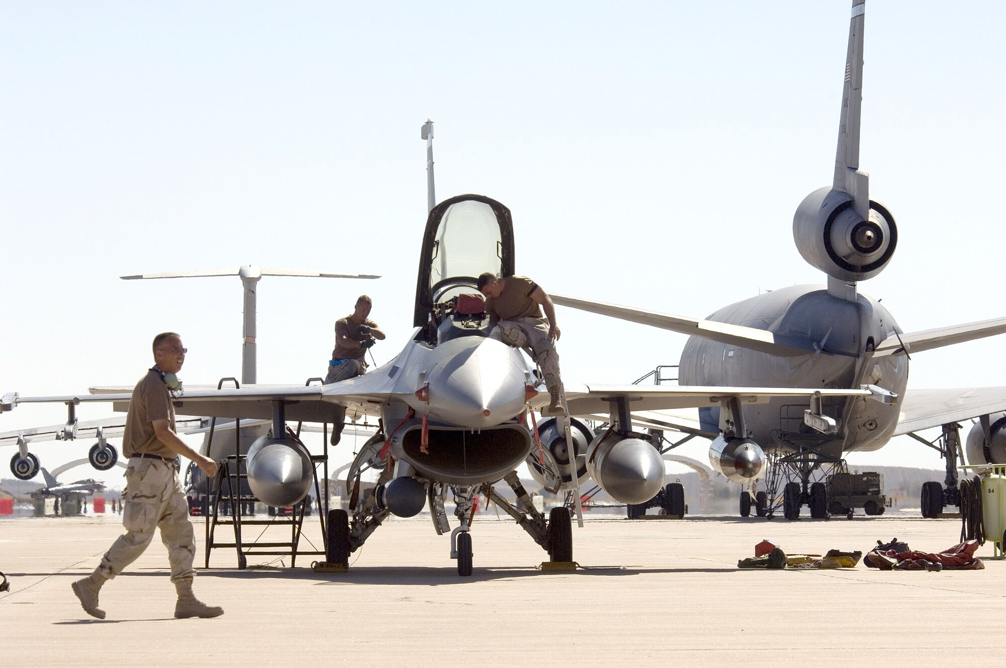 MORON AIR BASE, Spain -- An F-16 Fighting Falcon is serviced on the flightline here after "Coronet East" lands.  The Air Force reservists from the 180th Fighter Wing at Toledo, Ohio, are on their way home after supporting Operation Iraqi Freedom.  Coronet East is a title given to a group of jet fighters flying with necessary tankers for air refueling and an air transport with necessary maintenance support in tow.  (U.S. Air Force photo by Master Sgt. John E. Lasky) 