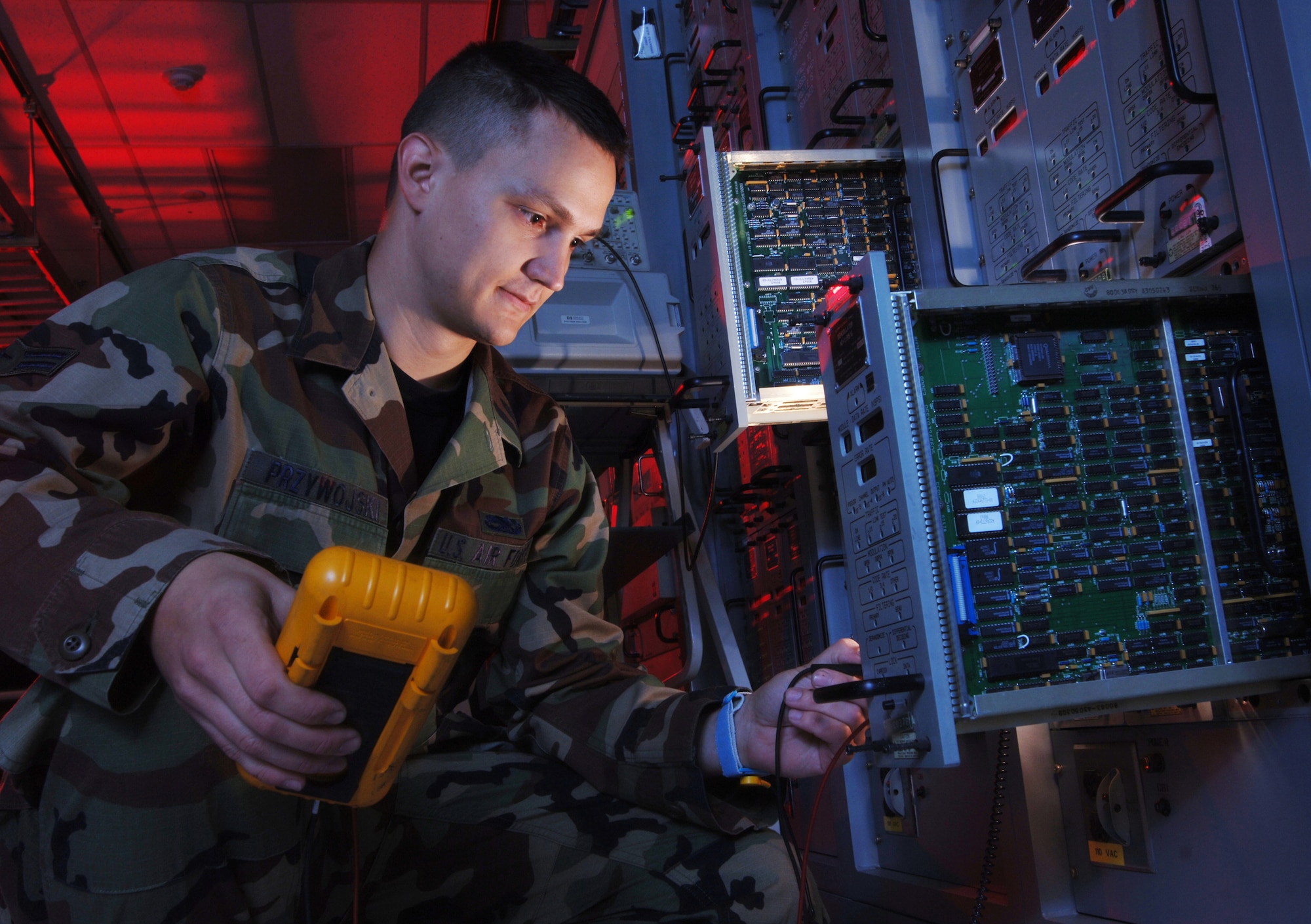 CAMP ZAMA, Japan -- Airman 1st Class Benjamin Pryzywojski aligns a modem demodulator circuit card.  He is a satellite communications technician with the 374th Communications Squadron's operating location-C.  The Airmen in OL-C here maintain communications links for the Department of Defense and its allies in the Pacific region.  (U.S. Air Force photo by Master Sgt. Val Gempis)