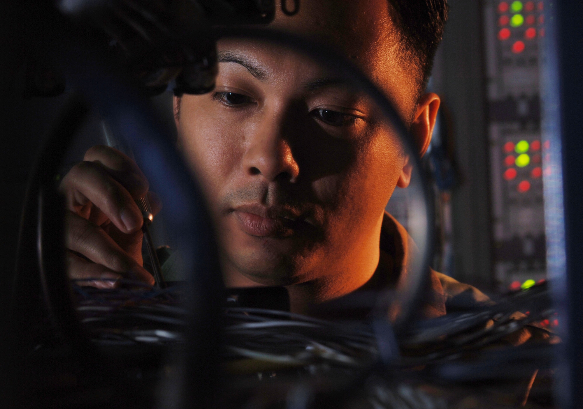 CAMP ZAMA, Japan -- Staff Sgt. Rico Sison uses a wire wrap tool to inspect block connectors on a distribution frame.  He is a systems control technician with the 374th Communications Squadron's operating location-C.  The Airmen in OL-C here maintain communications links for the Department of Defense and its allies in the Pacific region.  (U.S. Air Force photo by Master Sgt. Val Gempis)