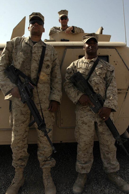 Lance Cpl. John W. Jackson (left), Lance Cpl. Joseph D. Canale (center) and Cpl. Kelvin L. Williams, are military policemen assigned to Combat Logistics Battalion Eight, MP Detachment, Alpha Company, 2nd Force Service Support Group (Forward). The battalion?s MP?s are tasked with providing security for virtually all vehicle movements outside of Camp Fallujah, Iraq. (Official Marine Corps photo by Sgt. Josh H. Hauser)(Released)