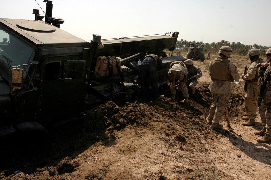 Marines assigned to Maintenance Company, Combat Logistics Battalion Eight, 2nd Force Service Support Group, begin work on removing an MK-36 wrecker weighing more than 10-tons which became mired in the mud in an area outside of Fallujah, Iraq Oct. 10. (Official Marine Corps photo by Sgt. Josh H. Hauser)(Released) Marines assigned to Maintenance Company, Combat Logistics Battalion Eight, 2nd Force Service Support Group, begin work on removing an MK-36 wrecker weighing more than 10-tons which became mired in the mud in an area outside of Fallujah, Iraq Oct. 10. (Official Marine Corps photo by Sgt. Josh H. Hauser)(Released)