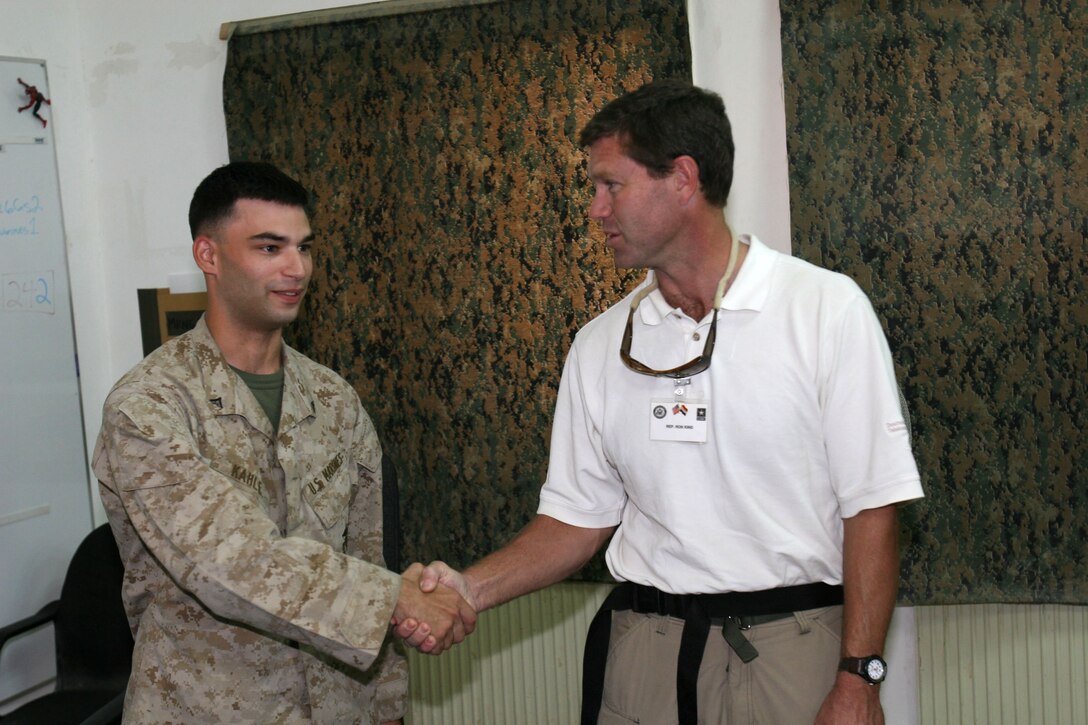Lance Cpl. Christopher Kahle, a Beloit, Wisc., native, takes a break from standing duty in Marine Medium Helicopter Squadron 266?s ready room to greet U.S. Rep. Ron Kind, Oct. 10., at Al Asad, Iraq. Kind, Wisconsin?s 3rd Congressional District representative, was one of six House members to get a firsthand view of the Marine Corps? Aviation Combat Element during an official congressional delegation visit to the Western Iraq air base.