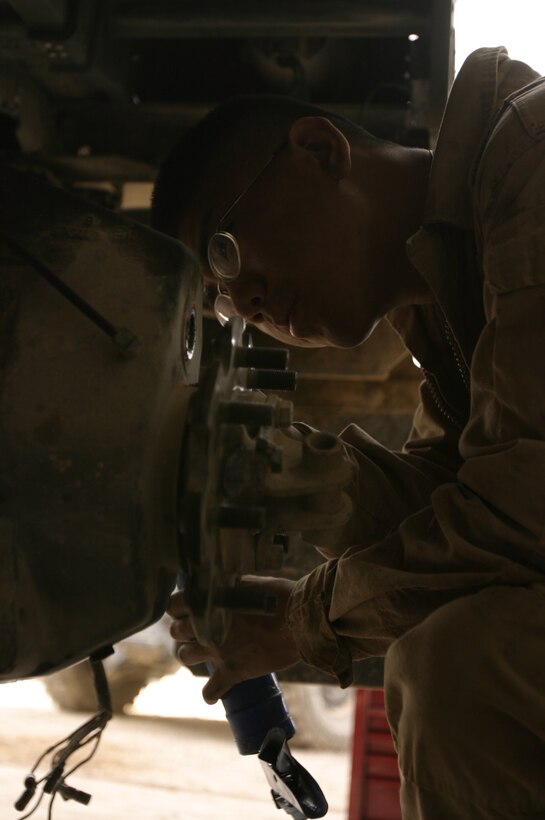 Lance Cpl. Albert Siu makes repairs Oct. 11 on a HUMVEE that received damage due to an improvised explosive attack. Siu is a 20-year-old native of Atlantic City, NJ, and a motor transportation mechanic assigned to Maintenance Company, Combat Logistics Battalion-8, 2nd Force Service Support Group (Forward) in Fallujah, Iraq.