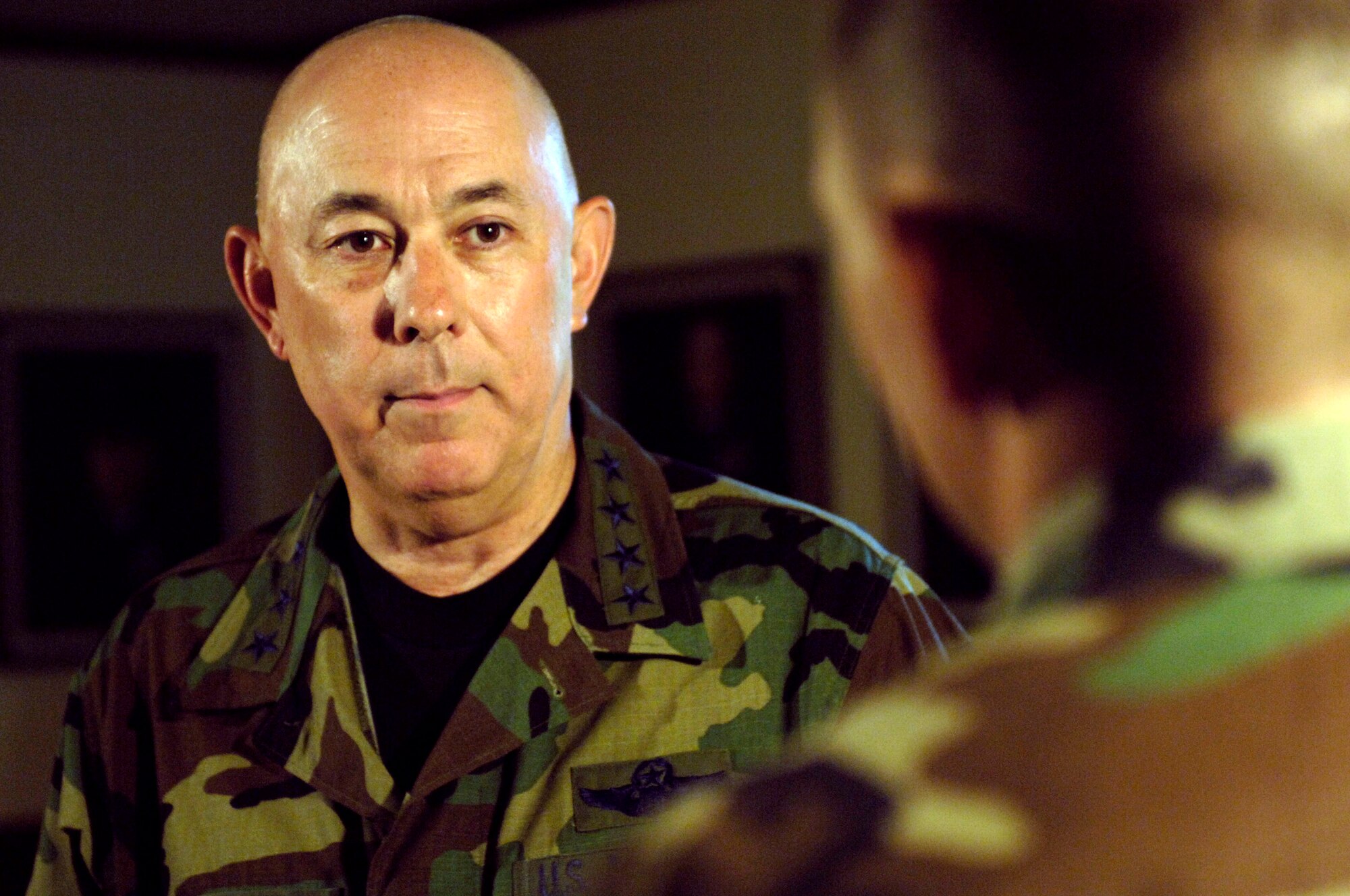 HICKAM AIR FORCE BASE, Hawaii -- Air Force Chief of Staff Gen. T. Michael Moseley talks to an Airman with the 15th Airlift Wing here Oct. 6. General Moseley is here holding a general officers call for the Pacific Air Forces theater. (U.S. Air Force photo by Tech. Sgt. Shane A. Cuomo) 