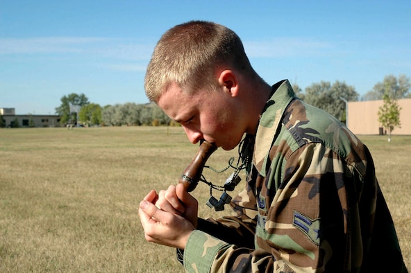 MINOT AIR FORCE BASE, N.D. -- Airman 1st Class Dustin Easton demonstrates how he uses a hand-made birdcall here during a practice session recently.  Airman Easton started bird calling when he was 10 years old when he went hunting with his grandfather. He is a champion bird caller and has competed in bird calling competitions nationwide.  He is assigned to the 5th Civil Engineer Squadron.  (U.S. Air Force photo by Senior Airman Danny Monahan)

