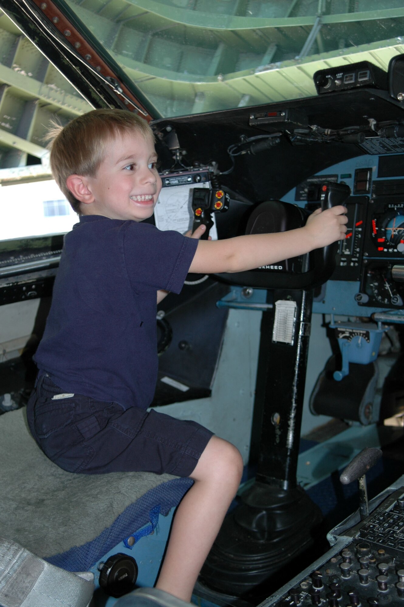 WRIGHT-PATTERSON AIR FORCE BASE, Ohio -- Ethan Sigler, 4, enjoys his turn in the pilot's seat of a C-5 Galaxy here. Ernie Sigler took his son to the C-5 arrival ceremony Oct. 3 so they could get a first-hand look at the plane. Mr. Sigler is an information technology program manager for the National Air and Space Intelligence Center's communication and information directorate. (U.S. Air Force photo by Tech. Sgt. Charlie Miller)