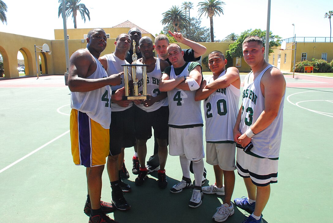 Headquarters and Service Battalion team members display their first-place trophy after dominating the Commanding General?s Cup basketball playoffs tournament Wednesday.