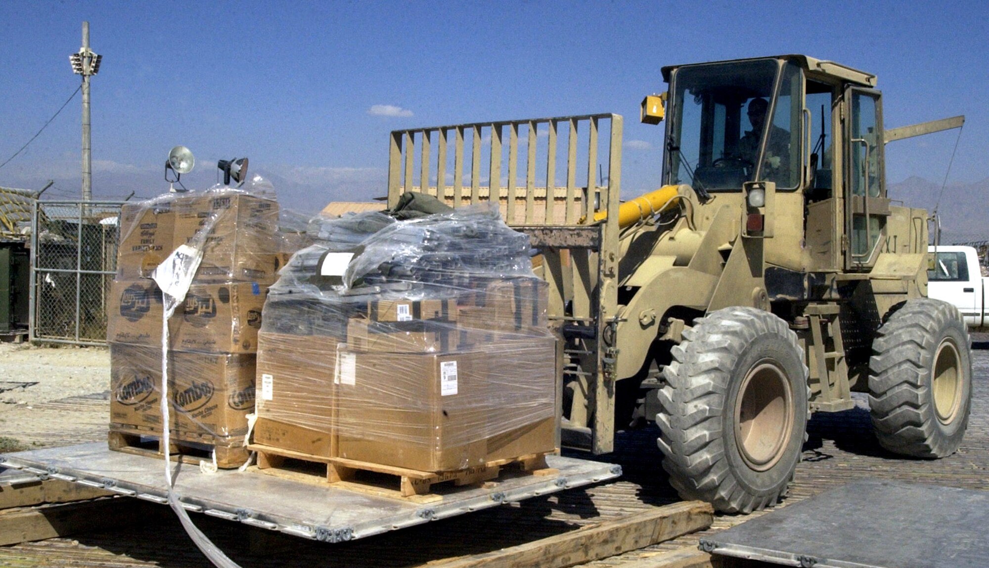 BAGRAM AIR BASE, Afghanistan -- Airman 1st Class Gregory Viruet picks up a pallet of cargo of earthquake relief supplies bound for Pakistan. The first relief supplies from the United States were ready for departure aboard a C-17 Globemaster III here less than 48 hours after the devastating earthquake left thousands dead and thousands more injured. More than 134,000 pounds of food, water, cots, medical supplies and American Red Cross items have been flown out of Bagram headed for Pakistan. Airman Viruet is a short takeoff and landing coordinator with the 455th Expeditionary Logistics Readiness Squadron.  He is deployed from McChord Air Force Base, Wash.  (U.S. Air Force photo by Staff Sgt. Marcus McDonald)