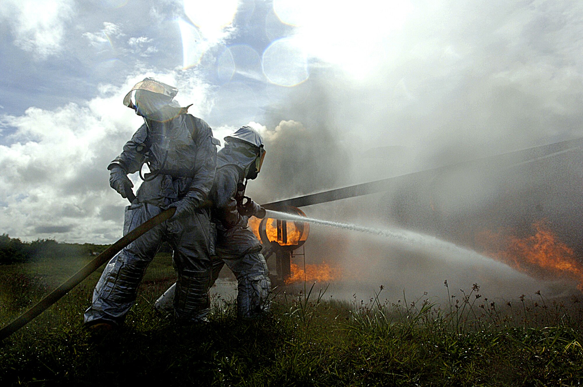 ANDERSEN AIR FORCE BASE, Guam -- Firefighters with the 36th Civil Engineer Squadron work to put out a fire as part of a simulated aircraft crash during Exercise Beverly Palm 05-07.  The routine exercise is held several times a year to sharpen the mobility and wartime capabilities of participating servicemembers.  (U.S. Air Force Photo by Staff Sgt. Bennie J. Davis III)